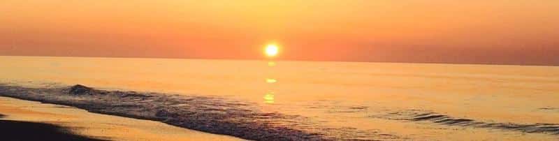 A bright orange sunset over the shores of North Carolina