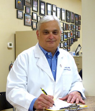 Dr. Mark Samia posing in his office